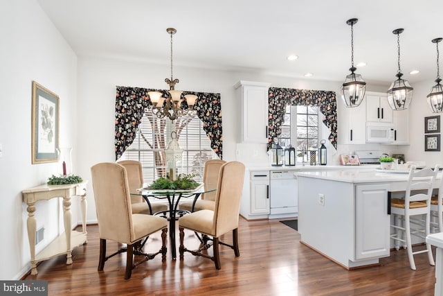 dining room featuring a notable chandelier and dark wood-type flooring