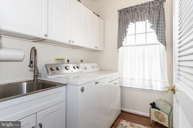 laundry room with sink, cabinets, washing machine and dryer, and dark hardwood / wood-style flooring