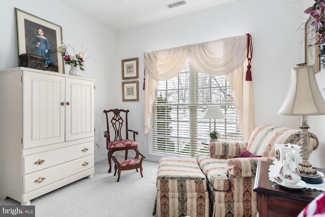 living area featuring light colored carpet