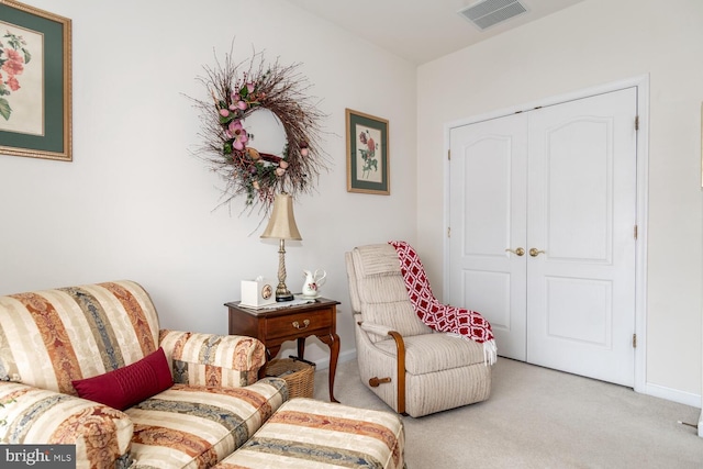 living area featuring light colored carpet