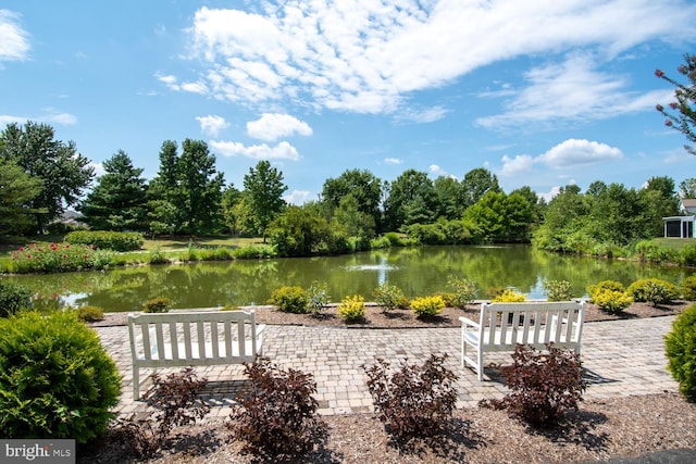 surrounding community with a patio area and a water view