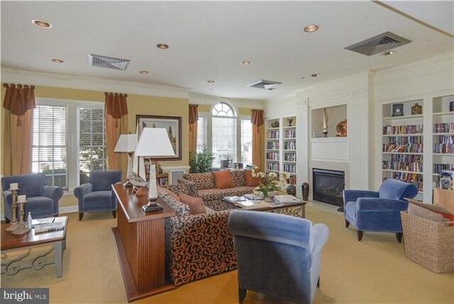 living room with crown molding, built in features, and carpet flooring