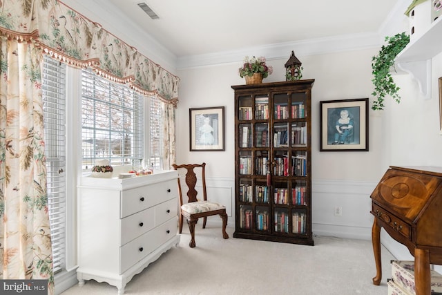 living area featuring light colored carpet and ornamental molding