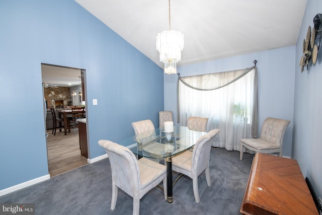 carpeted dining area with lofted ceiling and an inviting chandelier