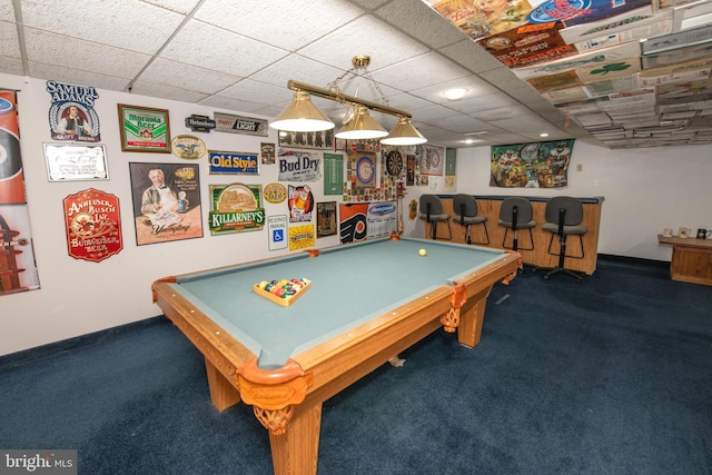 rec room with a paneled ceiling, billiards, dark colored carpet, and indoor bar