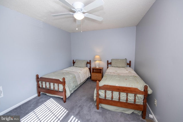 bedroom with ceiling fan, carpet flooring, and a textured ceiling