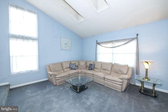 carpeted living room with lofted ceiling with skylight