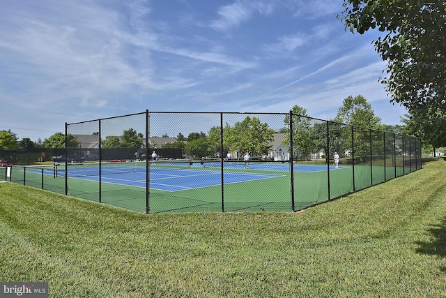 view of sport court with a yard