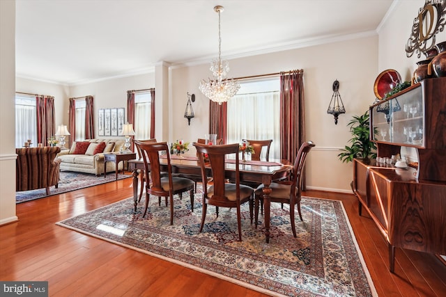 dining room featuring plenty of natural light, hardwood / wood-style flooring, and ornamental molding