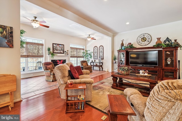 living room with ceiling fan and hardwood / wood-style floors