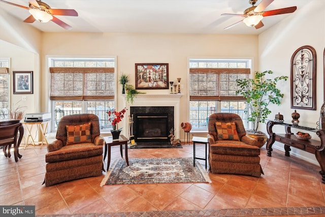 sitting room featuring tile patterned flooring and ceiling fan