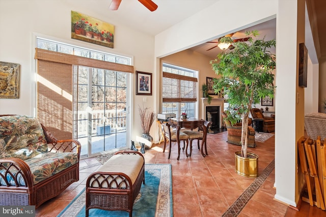 living area featuring ceiling fan and tile patterned floors