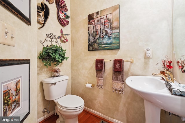 bathroom featuring sink, hardwood / wood-style flooring, and toilet