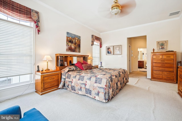 carpeted bedroom featuring ceiling fan, ensuite bathroom, and ornamental molding