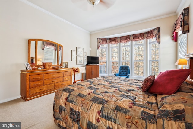 carpeted bedroom with ceiling fan and ornamental molding