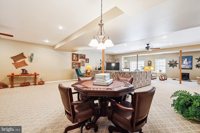 carpeted dining area with ceiling fan