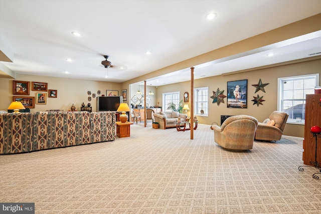 carpeted living room featuring plenty of natural light and ceiling fan