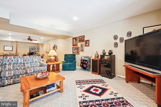 carpeted living room with ceiling fan