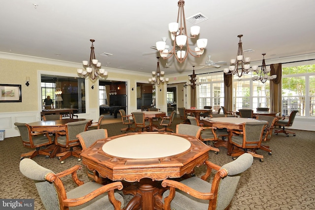 dining area featuring crown molding and a notable chandelier