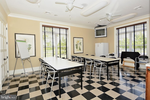 dining room featuring crown molding and ceiling fan