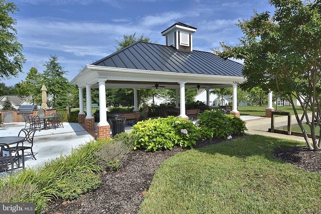 view of property's community featuring a gazebo, a patio, and a yard