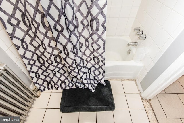 bathroom featuring tile patterned flooring and shower / tub combo with curtain