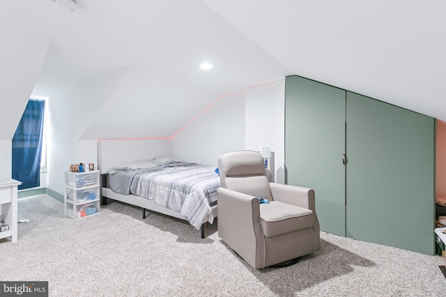 carpeted bedroom with vaulted ceiling