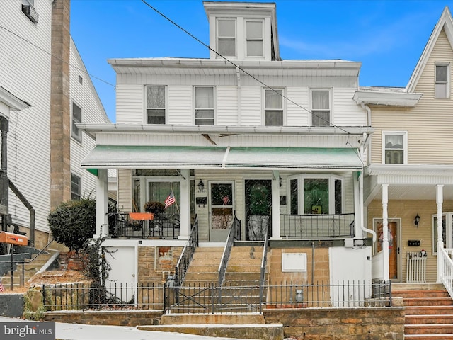 townhome / multi-family property featuring a porch