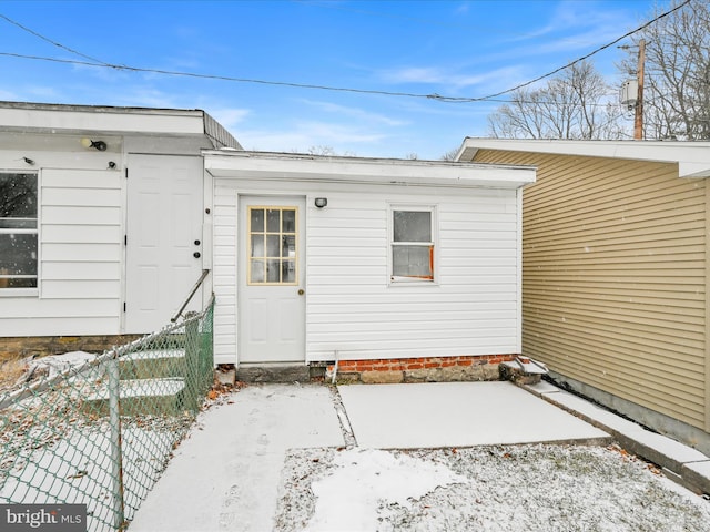 view of snow covered property entrance