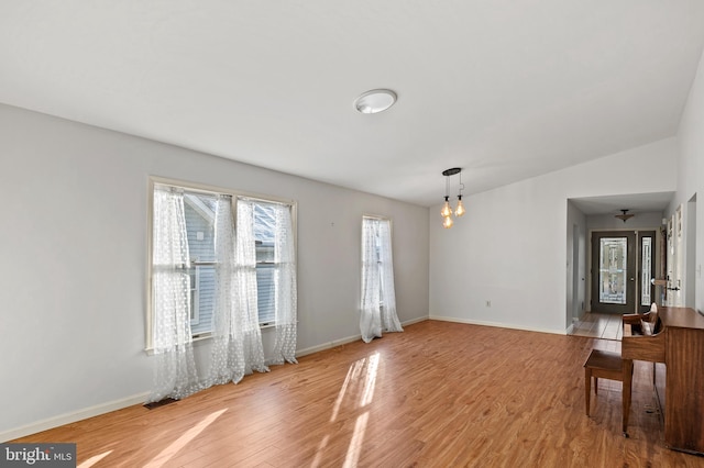 interior space featuring an inviting chandelier and light hardwood / wood-style flooring