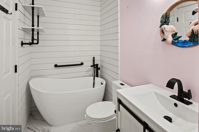 bathroom with a tub to relax in, toilet, and vanity