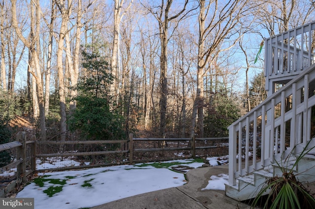 yard covered in snow featuring a patio