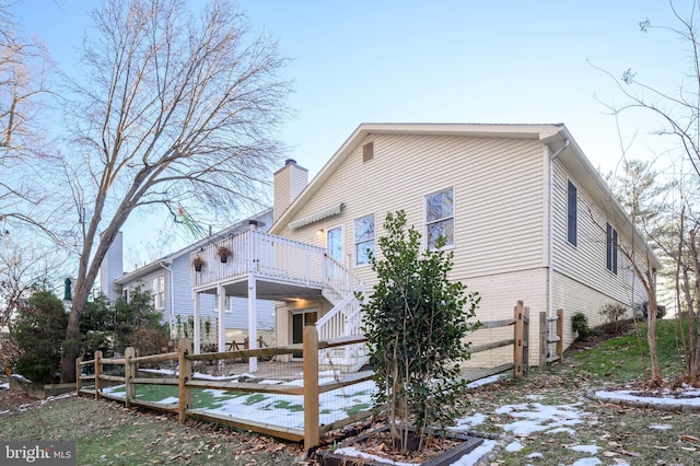 view of snow covered exterior featuring a wooden deck