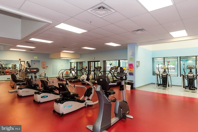 gym with a paneled ceiling