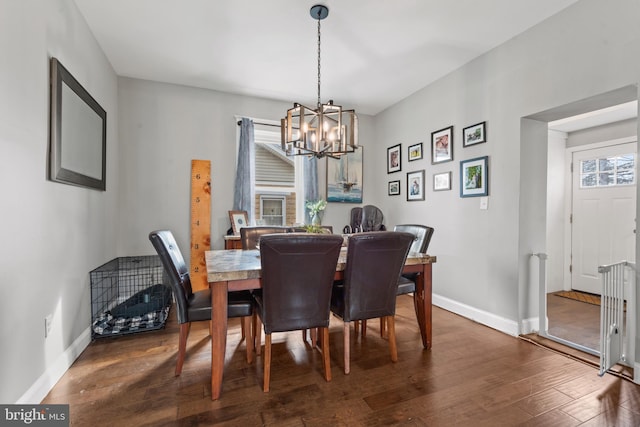 dining room with a notable chandelier and dark hardwood / wood-style floors