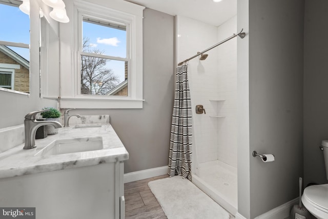 bathroom with a shower with curtain, vanity, toilet, and hardwood / wood-style floors