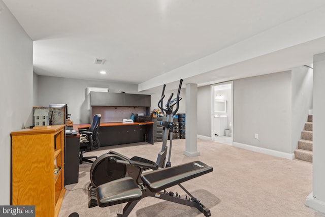 workout room featuring light carpet