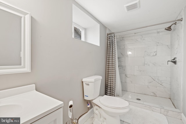 bathroom with vanity, toilet, and curtained shower