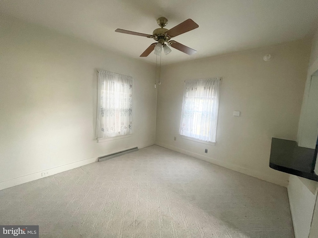 unfurnished room featuring ceiling fan, light colored carpet, and a baseboard heating unit