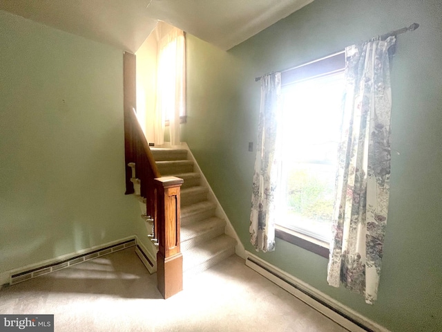 stairs featuring carpet floors, plenty of natural light, and a baseboard radiator