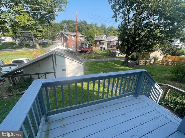 wooden deck featuring a yard