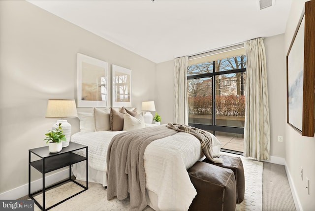 bedroom featuring light colored carpet and access to exterior