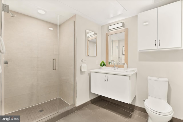 bathroom featuring an enclosed shower, vanity, tile patterned floors, and toilet