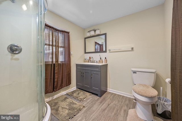 bathroom featuring toilet, vanity, wood-type flooring, decorative backsplash, and a shower with shower curtain