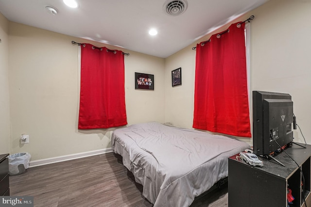 bedroom with dark hardwood / wood-style floors