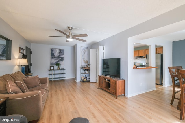 living room featuring ceiling fan and light hardwood / wood-style flooring