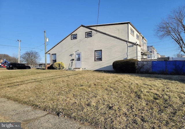 rear view of property with a yard