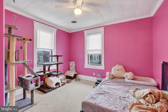 bedroom featuring ceiling fan, ornamental molding, and carpet flooring