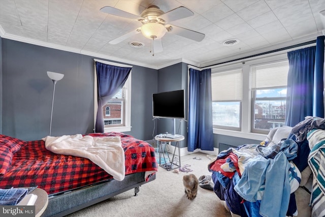 bedroom with ceiling fan, carpet floors, and ornamental molding