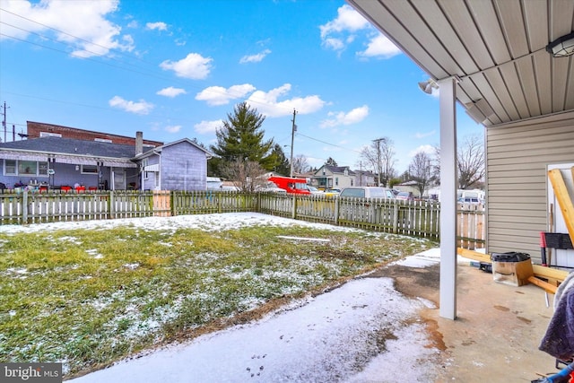 yard covered in snow with a patio area